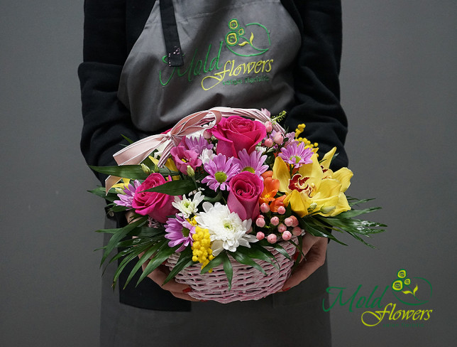 Basket with red roses, orange alstromerias, white eustomas, yellow and white chrysanthemums, yellow orchid photo